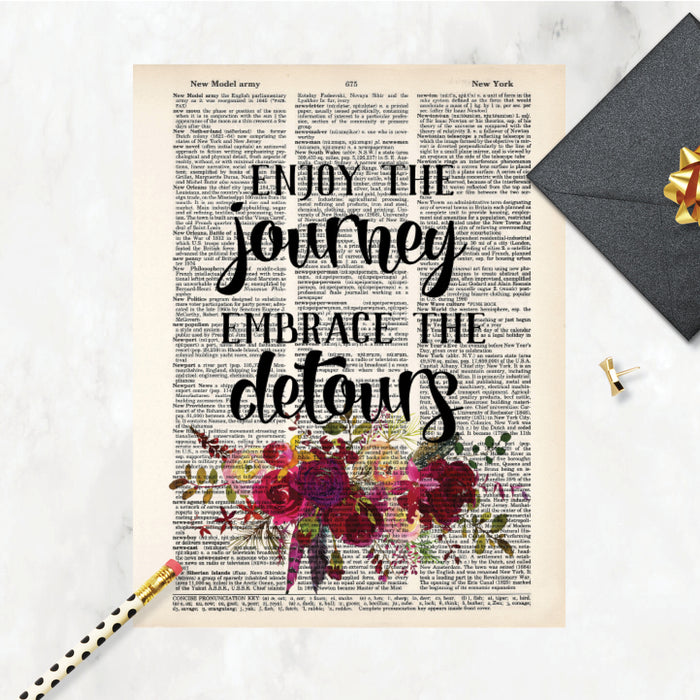 enjoy the journey embrace the detours quote with pink and red watercolor flowers and feathers on salvaged dictionary page