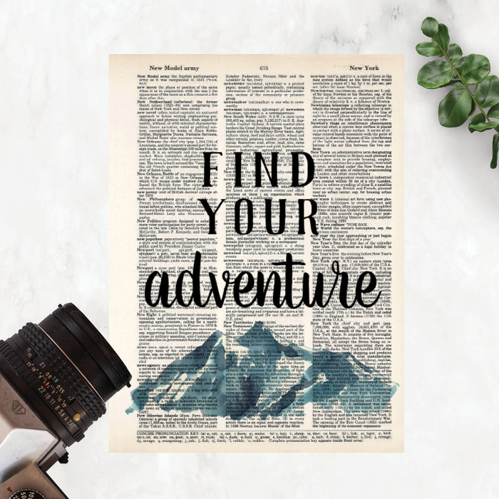 find your adventure in black ink above blueish gray mountains printed on salvaged dictionary page