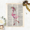 watercolor flamingo wearing a watercolor flower crown in shades of pink, purples, and blues she has high heels on her feet and one leg is kicked back printed on salvaged dictionary paper