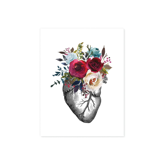 vintage etching of an anatomical heart topped with watercolor flowers in shades of reds and blues printed on matte white paper