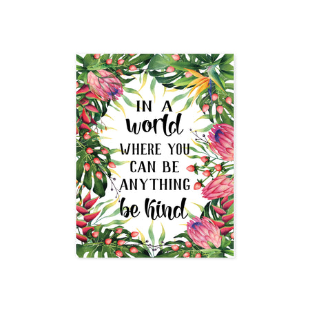 Tropical watercolor greenery and flowers surround the words In a world where you can be anything be kind on matte white paper