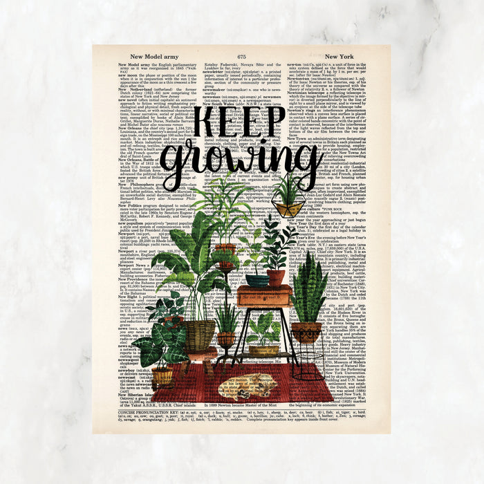 keep growing in black ink above a scene of plants on plant stands anchored by a rust colored rug with a yellow sleeping puppy printed on salvaged dictionary page