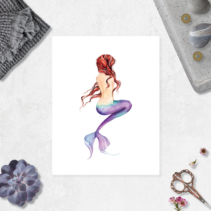 mermaid back view with long red hair and a purple tail printed on matte white paper