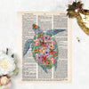 sea turtle in watercolors but with tropical flowers decorating the shell in shades of pink, purple, yellow printed on a dictionary page